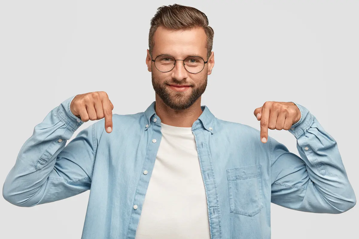 A man pointing down with both hands