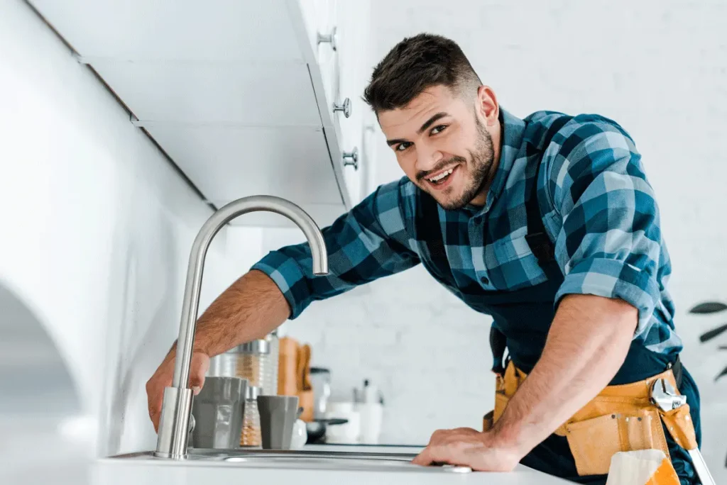 A tech getting ready to turn on a water faucet